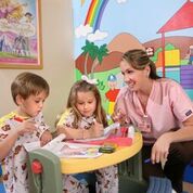 Pediatric nurse with two children coloring