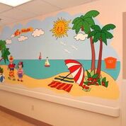 Illustrated cartoon mural of beach scape on wall of inpatient unit